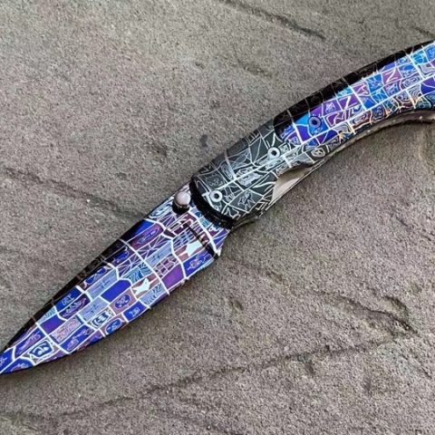 colorful quilt pattern damascus combined with a gray color version to make an interesting knife
