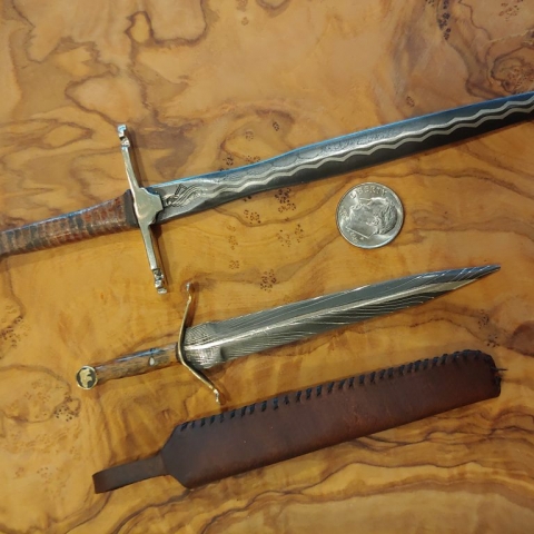 set of miniature daggers with dime for comparison
