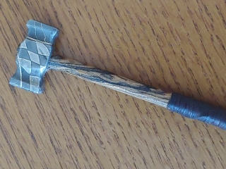 well made wood and steel hammer with damascus that matches the wood pattern