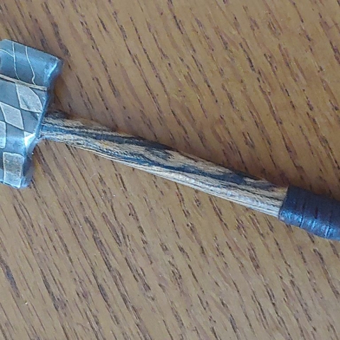 well made wood and steel hammer with damascus that matches the wood pattern