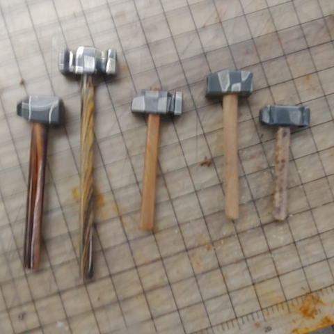 several hammers of different sizes made with different billets of steel
